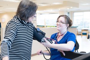 Nurse checking patient's blood pressure